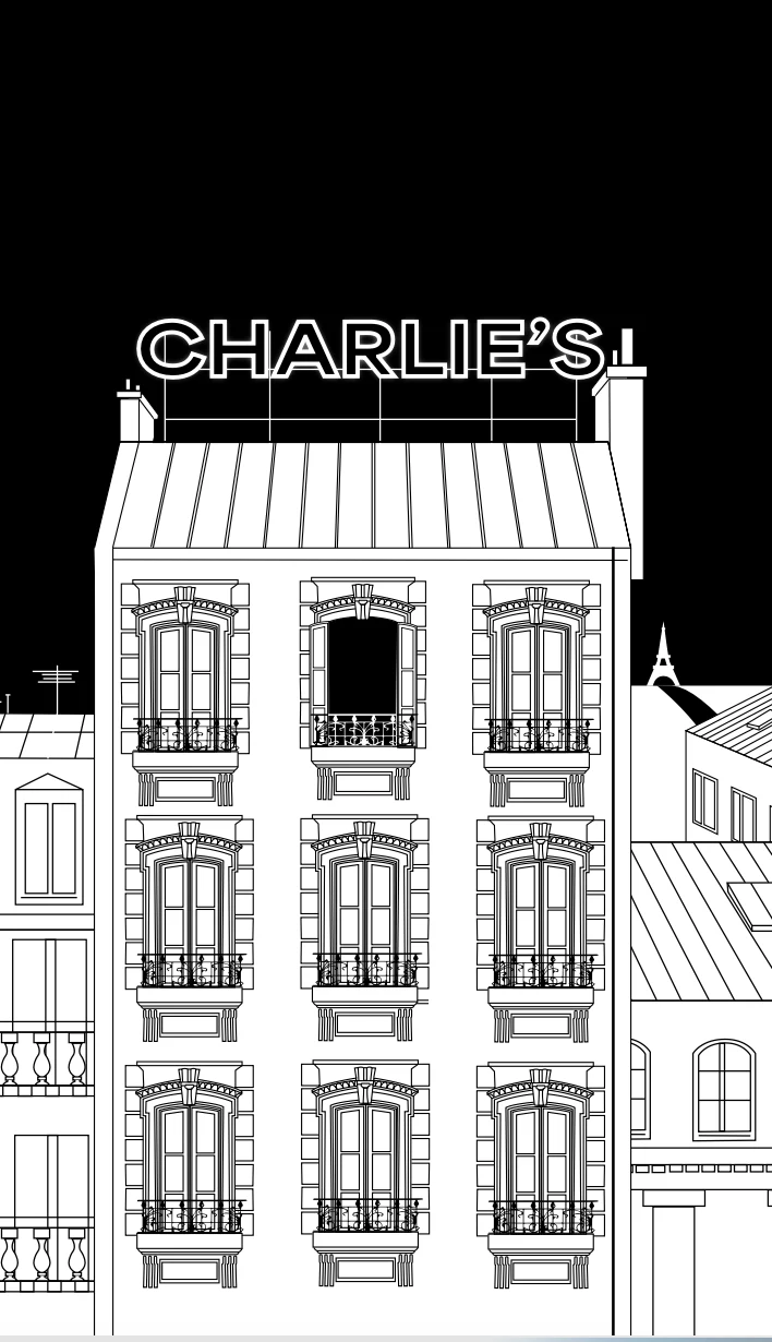 L'immeuble parisien de l'agence, enseigne Charlie's allumée sur le toit