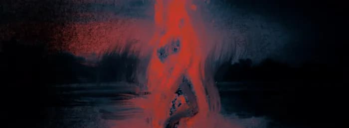 Une silhouette en flammes au bord de l'eau